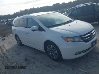 2014 Honda Odyssey Touring with VIN 5FNRL5H97EB127836, listed as a IAAI auction lot 41497413 with 174,914 mi miles and . Bid and sale history available at DreamBid. Image 1.