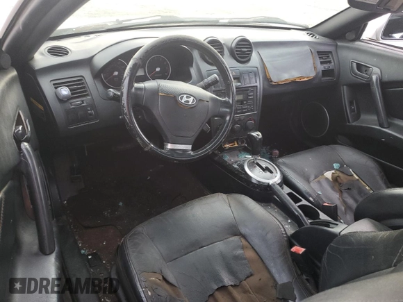 2003 Hyundai Tiburon GT z VIN KMHHN65F63U064962, wystawiony jako Copart lot #44804045 z przebiegiem 186 171 mil mil oraz Szkoda całkowita • Salvage title. Historia ofert i sprzedaży dostępna na DreamBid. Obrazek 8.