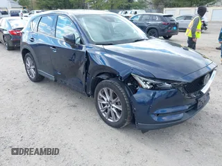 2019 Mazda CX-5 Grand Touring with VIN JM3KFBDM2K0603400, listed as a IAAI auction lot 42051135 with 59,448 mi miles and . Bid and sale history available at DreamBid. Image 1.