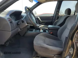 2000 Jeep Grand Cherokee Laredo z VIN 1J4GW48N9YC239166, wystawiony jako Copart lot #53321135 z przebiegiem 142 162 mil mil oraz Szkoda całkowita • Salvage title. Historia ofert i sprzedaży dostępna na DreamBid. Obrazek 7.