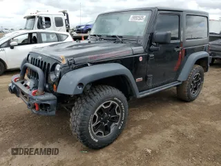 2013 Jeep Wrangler Rubicon 10th Anniversary z VIN 1C4BJWCG7DL677164, wystawiony jako Copart lot #59992505 z przebiegiem 120 000 mil mil oraz Szkoda całkowita • Salvage title. Historia ofert i sprzedaży dostępna na DreamBid. Obrazek 1.