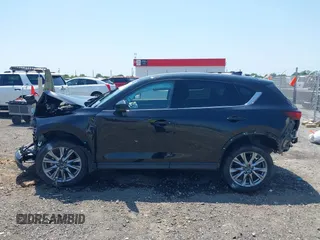 2020 Mazda CX-5 Grand Touring with VIN JM3KFADM9L1837183, listed as a IAAI auction lot 42340628 with 81,975 mi miles and . Bid and sale history available at DreamBid. Image 14.