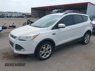 2014 Ford Escape SE with VIN 1FMCU9GX9EUB15944, listed as a IAAI auction lot 42110269 with 120,297 mi miles and . Bid and sale history available at DreamBid. Image 2.