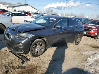 2020 BMW X2 xDrive28i with VIN WBXYJ1C00L5P51384, listed as a Copart auction lot 87406814 with 52,807 mi miles and Salvage Title. Bid and sale history available at carsss.com. Image 1.