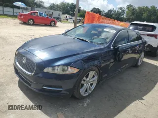 2013 Jaguar XJ Portfolio with VIN SAJWA2G13DLV57203, listed as a Copart auction lot 63496995 with 124,879 mi miles and Salvage title. Bid and sale history available at DreamBid. Image 1.