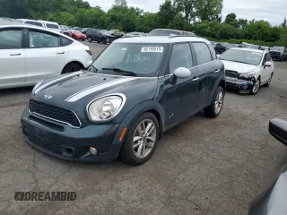 2014 MINI Countryman S with VIN WMWZC5C58EWP39797, listed as a Copart auction lot 62193515 with 84,989 mi miles and Salvage title. Bid and sale history available at DreamBid. Image 1.