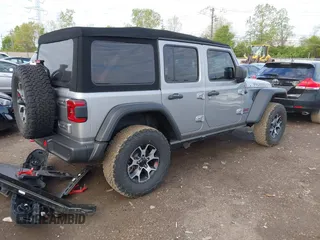 2021 Jeep Wrangler Unlimited Rubicon with VIN 1C4HJXFNXMW560512, listed as a IAAI auction lot 42124812 with 18,034 mi miles and . Bid and sale history available at DreamBid. Image 4.