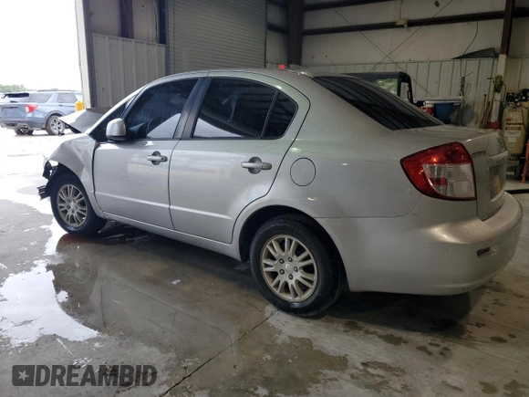 2012 Suzuki SX4 LE z VIN JS2YC5A34C6304150, wystawiony jako Copart lot #48629255 z przebiegiem 104 658 mil mil oraz Szkoda całkowita • Salvage title. Historia ofert i sprzedaży dostępna na DreamBid. Obrazek 2.