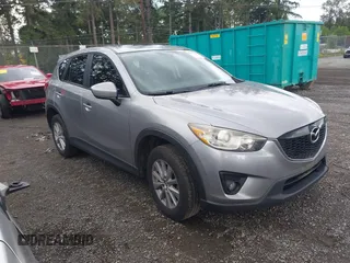2014 Mazda CX-5 Touring z VIN JM3KE4CY8E0424382, wystawiony jako IAAI lot #42323990 z przebiegiem 127 578 mil mil oraz . Historia ofert i sprzedaży dostępna na DreamBid. Obrazek 1.