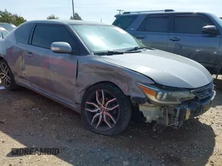 2014 Scion tC with VIN JTKJF5C78E3075164, listed as a IAAI auction lot 41922609 with 142,064 mi miles. Bid and sale history available at carsss.com. Image 1.