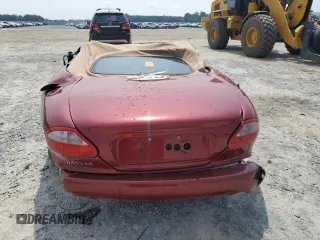 1999 Jaguar XK with VIN SAJGX204XXC038435, listed as a Copart auction lot 64843714 with Not Provided miles and Salvage Title. Bid and sale history available at DreamBid. Image 6.