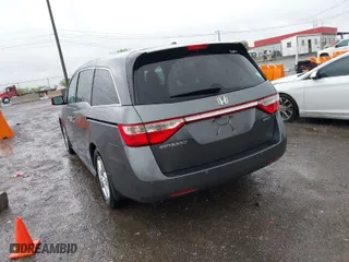 2012 Honda Odyssey Touring with VIN 5FNRL5H92CB073455, listed as a IAAI auction lot 42091700 with 243,919 mi miles. Bid and sale history available at carsss.com. Image 3.
