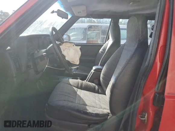 1999 Jeep Cherokee SE with VIN 1J4FT28S6XL515896, listed as a Copart auction lot 83745444 with 192,406 mi miles and Salvage title. Bid and sale history available at DreamBid. Image 7.