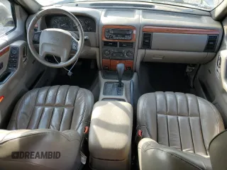 1999 Jeep Grand Cherokee Limited with VIN 1J4G268S7XC668348, listed as a Copart auction lot 77824084 with 165,779 mi miles and Salvage title. Bid and sale history available at DreamBid. Image 8.