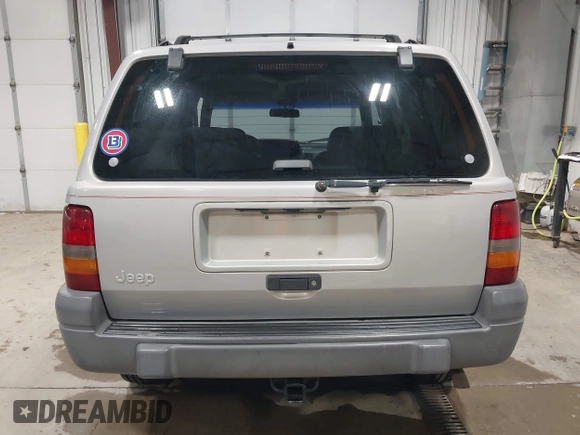1996 Jeep Grand Cherokee Laredo z VIN 1J4GZ58S5TC293897, wystawiony jako IAAI lot #42435233 z przebiegiem 167 432 mil mil oraz . Historia ofert i sprzedaży dostępna na DreamBid. Obrazek 16.