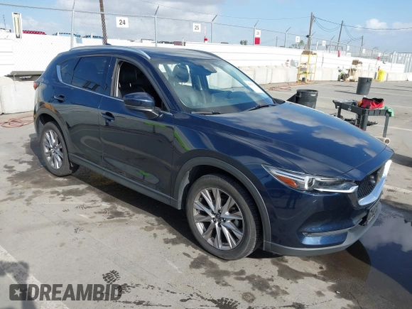2021 Mazda CX-5 Grand Touring with VIN JM3KFBDM6M1312573, listed as a IAAI auction lot 41936739 with Not Provided miles and . Bid and sale history available at DreamBid. Image 1.
