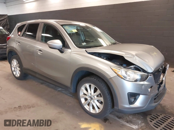 2014 Mazda CX-5 Grand Touring with VIN JM3KE4DY9E0373974, listed as a IAAI auction lot 42073693 with 86,755 mi miles. Bid and sale history available at carsss.com. Image 1.