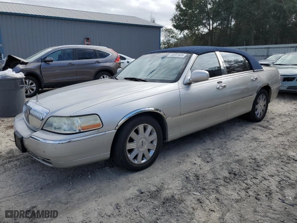 2003 Lincoln Town Car Cartier with VIN 1LNHM83W23Y639990, listed as a Copart auction lot 85591924 with 124,515 mi miles and Salvage Title. Bid and sale history available at carsss.com. Image 1.