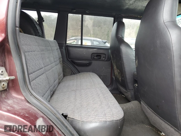 2000 Jeep Cherokee z VIN 1J4FF48S0YL254270, wystawiony jako Copart lot #52589415 z przebiegiem 166 860 mil mil oraz Szkoda całkowita • Salvage title. Historia ofert i sprzedaży dostępna na DreamBid. Obrazek 11.