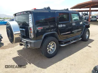 2003 Hummer H2 with VIN 5GRGN23U73H122756, listed as a IAAI auction lot 42194176 with 239,411 mi miles. Bid and sale history available at carsss.com. Image 4.