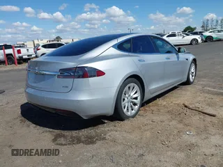 2016 Tesla Model S 90D with VIN 5YJSA1E22GF174637, listed as a IAAI auction lot 42234083 with 142,915 mi miles and . Bid and sale history available at DreamBid. Image 4.