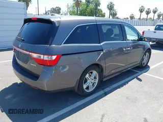 2012 Honda Odyssey Touring with VIN 5FNRL5H98CB011297, listed as a IAAI auction lot 42207061 with 154,073 mi miles and . Bid and sale history available at DreamBid. Image 4.