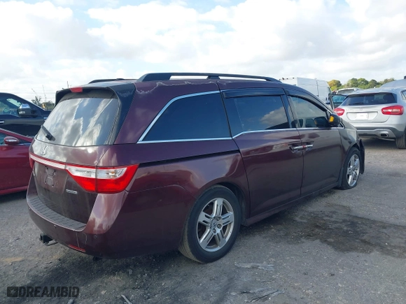 2011 Honda Odyssey Touring with VIN 5FNRL5H97BB008759, listed as a IAAI auction lot 41567010 with 215,709 mi miles. Bid and sale history available at carsss.com. Image 4.