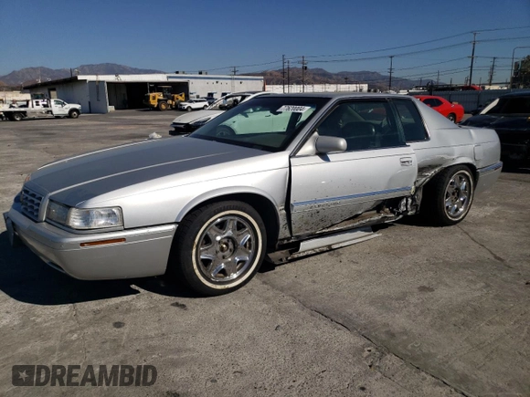 1999 Cadillac Eldorado z VIN 1G6EL12Y0XU604529, wystawiony jako Copart lot #77620004 z przebiegiem 246 032 mil mil oraz Szkoda całkowita • Salvage title. Historia ofert i sprzedaży dostępna na DreamBid. Obrazek 1.