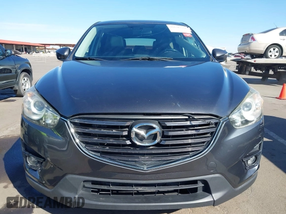 2016 Mazda CX-5 Grand Touring z VIN JM3KE2DYXG0649781, wystawiony jako IAAI lot #41636329 z przebiegiem 83 433 mil mil oraz . Historia ofert i sprzedaży dostępna na DreamBid. Obrazek 12.