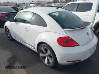2012 Volkswagen Beetle 2.0T Turbo w/Sun/Snd/Nav PZEV with VIN 3VWVA7ATXCM620731, listed as a IAAI auction lot 41074530 with 99,236 mi miles. Bid and sale history available at carsss.com. Image 3.
