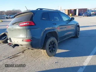 2015 Jeep Cherokee Trailhawk with VIN 1C4PJMBSXFW614416, listed as a IAAI auction lot 41033241 with 112,015 mi miles. Bid and sale history available at carsss.com. Image 4.