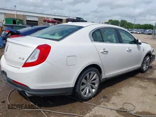 2014 Lincoln MKS z VIN 1LNHL9DK7EG601720, wystawiony jako IAAI lot #42464979 z przebiegiem 58 163 mil mil oraz . Historia ofert i sprzedaży dostępna na DreamBid. Obrazek 13.