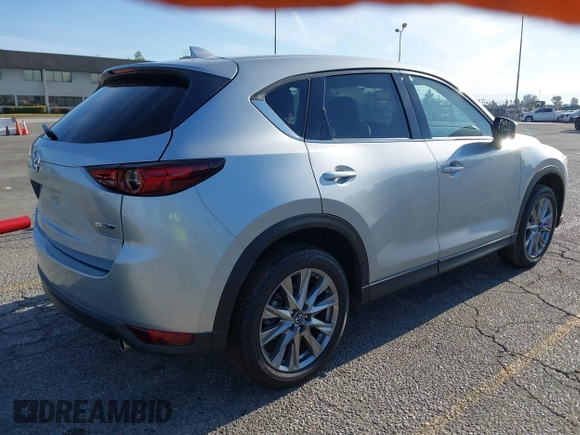 2021 Mazda CX-5 Grand Touring with VIN JM3KFADM1M1393251, listed as a IAAI auction lot 42072862 with 47,758 mi miles. Bid and sale history available at carsss.com. Image 4.