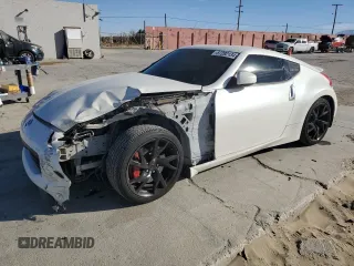 2014 Nissan 370Z Nismo with VIN JN1AZ4EH0EM635111, listed as a Copart auction lot 87292134 with 185,356 mi miles and Salvage Title. Bid and sale history available at DreamBid. Image 1.