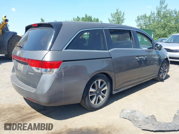 2014 Honda Odyssey Touring with VIN 5FNRL5H90EB082691, listed as a IAAI auction lot 42572977 with 54,413 mi miles and . Bid and sale history available at DreamBid. Image 4.