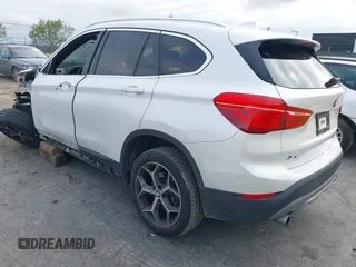 2018 BMW X1 sDrive28i with VIN WBXHU7C38J5L05985, listed as a IAAI auction lot 42014649 with 77,082 mi miles. Bid and sale history available at carsss.com. Image 3.