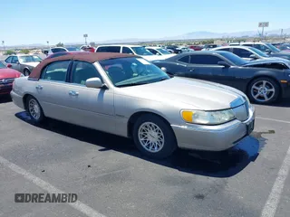 1999 Lincoln Town Car Signature with VIN 1LNHM82W0XY690945, listed as a IAAI auction lot 42632705 with 210,109 mi miles and . Bid and sale history available at DreamBid. Image 1.