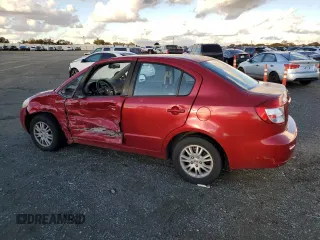 2013 Suzuki SX4 LE with VIN JS2YC5A37D6101819, listed as a Copart auction lot 82367044 with 142,932 mi miles and Salvage Title. Bid and sale history available at carsss.com. Image 2.
