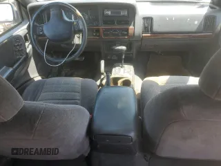 1997 Jeep Grand Cherokee Laredo z VIN 1J4GZ58S6VC636803, wystawiony jako Copart lot #59977115 z przebiegiem Nie podano mil oraz Szkoda całkowita • Salvage title. Historia ofert i sprzedaży dostępna na DreamBid. Obrazek 8.