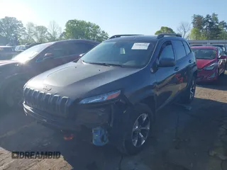 2014 Jeep Cherokee Trailhawk with VIN 1C4PJMBS6EW167517, listed as a IAAI auction lot 41947552 with 233,572 mi miles. Bid and sale history available at carsss.com. Image 2.