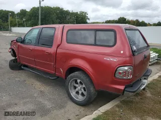 2001 Ford F-150 SuperCrew XLT with VIN 1FTRW08W01KE02928, listed as a Copart auction lot 73629704 with 313,859 mi miles and Salvage Title. Bid and sale history available at carsss.com. Image 2.