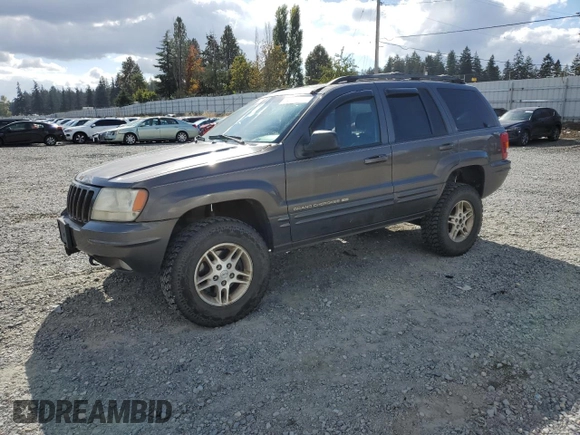 1999 Jeep Grand Cherokee Limited with VIN 1J4GW68S2XC677334, listed as a Copart auction lot 74152054 with 242,220 mi miles and Salvage Title. Bid and sale history available at carsss.com. Image 1.