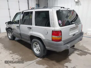 1996 Jeep Grand Cherokee Laredo z VIN 1J4GZ58S5TC293897, wystawiony jako IAAI lot #42435233 z przebiegiem 167 432 mil mil oraz . Historia ofert i sprzedaży dostępna na DreamBid. Obrazek 3.