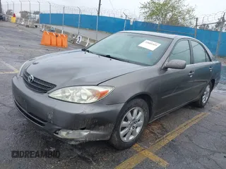 2004 Toyota Camry LE with VIN JTDBF32K740152841, listed as a IAAI auction lot 41808909 with 142,611 mi miles. Bid and sale history available at carsss.com. Image 2.