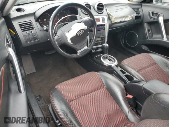 2006 Hyundai Tiburon GT z VIN KMHHN65F66U215304, wystawiony jako Copart lot #56141635 z przebiegiem 149 118 mil mil oraz Szkoda całkowita • Salvage title. Historia ofert i sprzedaży dostępna na DreamBid. Obrazek 8.