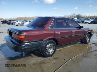 1989 Toyota Camry DLX z VIN 4T1SV21E3KU053153, wystawiony jako Copart lot #49917485 z przebiegiem 79 028 mil mil oraz Szkoda całkowita • Salvage title. Historia ofert i sprzedaży dostępna na DreamBid. Obrazek 3.