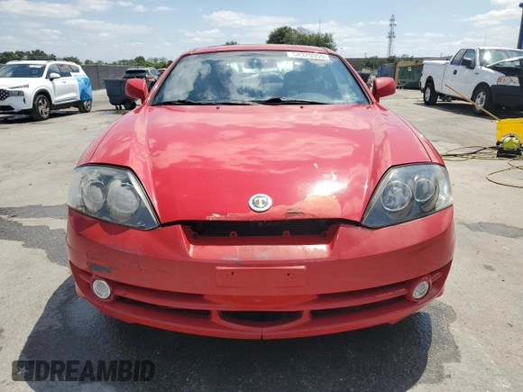 2003 Hyundai Tiburon GT z VIN KMHHN65F33U088538, wystawiony jako Copart lot #54320955 z przebiegiem 220 732 mil mil oraz Szkoda całkowita • Salvage title. Historia ofert i sprzedaży dostępna na DreamBid. Obrazek 5.