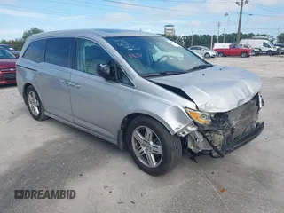 2011 Honda Odyssey Touring with VIN 5FNRL5H9XBB013213, listed as a IAAI auction lot 41934875 with 220,525 mi miles and . Bid and sale history available at DreamBid. Image 1.