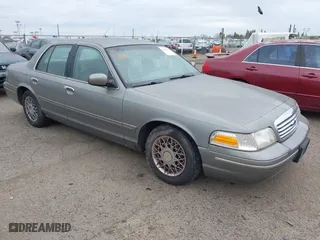 1999 Ford Crown Victoria LX with VIN 2FAFP74W4XX192490, listed as a IAAI auction lot 41791909 with 115,469 mi miles. Bid and sale history available at carsss.com. Image 1.