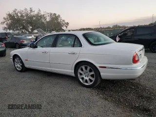 2004 Jaguar XJ with VIN SAJWA71C14SG16264, listed as a Copart auction lot 83251554 with 267,493 mi miles and Salvage Title. Bid and sale history available at carsss.com. Image 2.